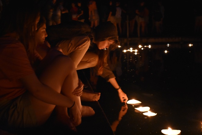 Placing the candles in the lake